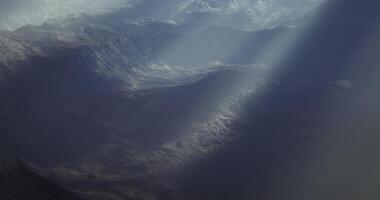 CGI Mountain landscape with rays of sunlight piercing through clouds video