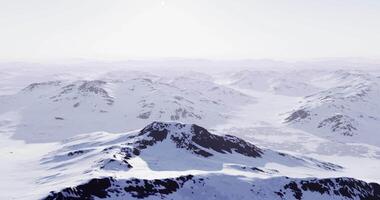 CGI Snowy mountain range under clear sky in winter landscape during daylight video
