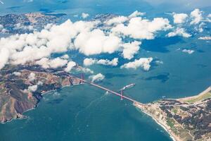 Aerial view of the golden gate bridge with clouds and coastline on a bright sunny day in san francisco photo