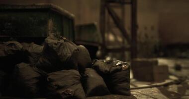CGI Garbage bags piled in a dimly lit abandoned warehouse setting video