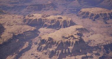 CGI Stunning aerial view of rugged mountains and distant canyons at midday video