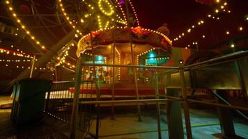 The CGI Empty amusement park at night with illuminated rides and quiet atmosphere video