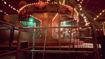 The cinematic CGI Empty amusement park at night with illuminated carousel and quiet surroundings video