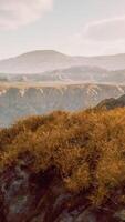 CGI Autumn mountain valley against blue cloudy sky video