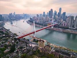 Chongqing, China-APR 03, 2025-twilight Cityscape of the famous downtown shopping complex and CBD with illuminated bridge and highrise building in Chongqing, China photo