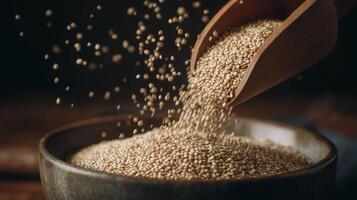 Quinoa grains cascade from a wooden scoop into a rustic bowl, creating a warm, inviting ambiance. photo