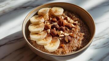 A nutritious bowl features quinoa, sliced bananas, and a mix of nuts, beautifully arranged. photo
