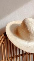 Straw Hat Resting on a Wooden Chair in a Sunlit Corner of a Cozy Room photo
