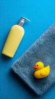 Bath Time Essentials With a Rubber Duck on a Bright Blue Background. photo