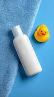 Bath Time Essentials With a Rubber Duck on a Bright Blue Background photo