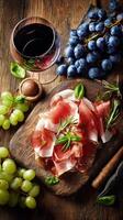Delightful Charcuterie Board With Cured Meats, Grapes, and Red Wine at a Rustic Table. photo