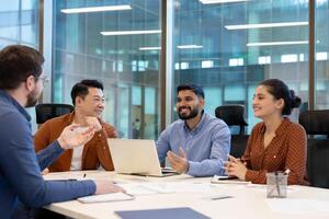 A diverse group of colleagues collaborates in a modern office meeting room, discussing ideas and strategies. photo