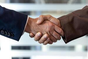 Two businessmen shaking hands. The image captures the essence of agreement and collaboration within a professional setting. photo