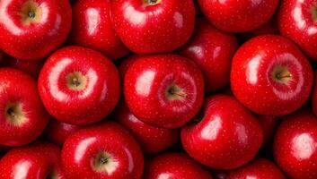 Vibrant display of red apples. A close view of shiny red apples piled together, showcasing their smooth skin and natural shine in bright light. photo