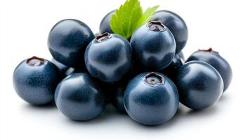 Fresh blueberries arranged with a leaf. A cluster of fresh blueberries showcases vibrant color and texture, accented by a green leaf for freshness. photo