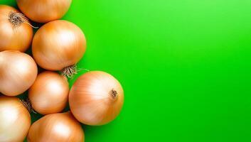 Fresh brown onions on green. Several brown onions rest on a vibrant green surface showcasing their smooth skin and natural textures. photo