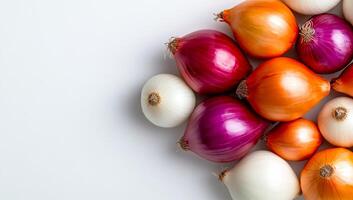 Fresh, colorful onions displayed. A colorful assortment of red, yellow, and white onions displayed on a light background. photo