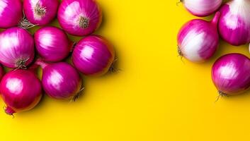 Onions on yellow background. Vibrant red and white onions arranged on a bright yellow surface, showcasing their rich colors and textures. photo