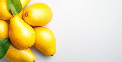 Yellow pears on a white bg. Fresh yellow pears with green leaves are neatly arranged on a clean white background, showcasing their vibrant color. photo