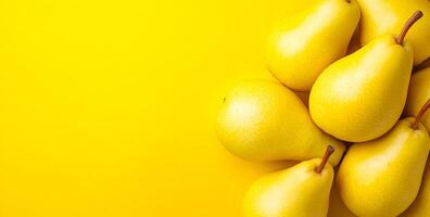 Bright yellow pears on yellow. A cluster of ripe yellow pears sits on a bright surface, showcasing their fresh look in natural light. photo