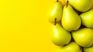 Green pears on yellow backdrop. A cluster of bright green pears rests on a lively yellow background, showcasing their smooth texture and healthy appeal. photo