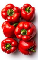 Vibrant red peppers arranged together. Fresh red bell peppers are grouped closely, showcasing their shiny skin and plump form in a bright setting. photo