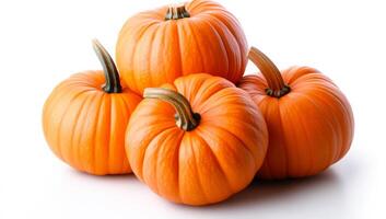 Stacked colorful pumpkins for fall. Four orange pumpkins are stacked, showing their textured surfaces and green stems a perfect fall decoration. photo