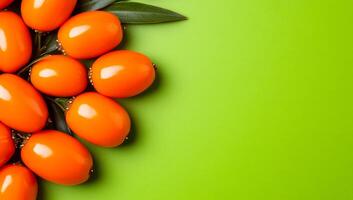 Sea buckthorn on green backdrop. Fresh Sea buckthorn is artfully arranged with green leaves on a bright green surface, creating a lively display. photo
