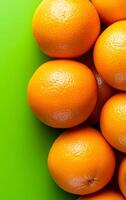 Oranges on green backdrop. Bright oranges are piled together on a lively green surface, showcasing their texture and freshness. photo
