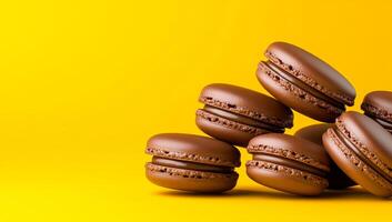 Chocolate macarons on yellow. Seven chocolate macarons are stacked elegantly on a bright yellow background, showcasing their glossy texture and color. photo