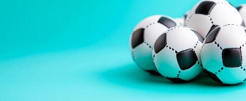 Soccer balls on blue bg. Multiple classic soccer balls are arranged against a vibrant blue background, showcasing their black and white pattern. photo