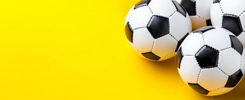 Soccer balls on yellow bg. Four soccer balls are positioned in a triangular formation against a vibrant yellow background, creating a playful vibe. photo