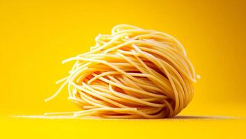 Spaghetti on a bright yellow background. A tangled ball of uncooked spaghetti sits on a vibrant yellow surface, highlighting its texture and color. photo