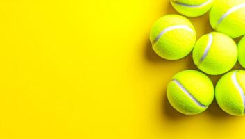 Neatly arranged yellow tennis balls. Vibrant yellow tennis balls are clustered together on a vivid yellow background, highlighting their texture and color. photo