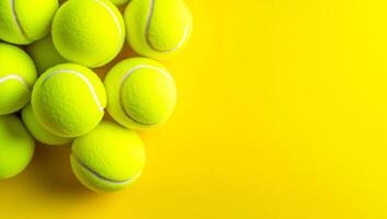 Yellow tennis balls on bright bg. Pile of bright yellow tennis balls rests on a vibrant yellow surface, creating a lively and dynamic visual effect. photo