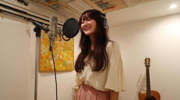 Talented Female Singer Recording a Song in a Professional Music Studio. Captivating Voice and Passionate Performance. High Quality Audio and Visuals photo