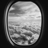 A breathtaking monochrome view of fluffy clouds from an airplane window, capturing the serene beauty of a high altitude flight and photo