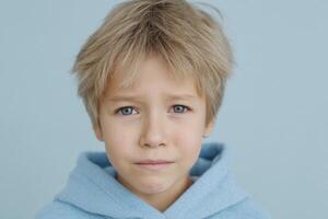 portrait of a cute boy with blond hair and blue eyes. The child's innocent expression is captivating, evoking feelings of warmth photo