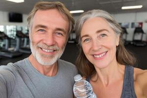 Active Senior Couple Smiling at the Gym. Healthy Lifestyle, Fitness, and Wellness. Exercise and Workout for Older Adults. A Port photo