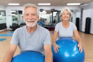 Active Seniors Fitness and Wellness in the Gym. Smiling Elderly Couple Enjoying a Pilates Exercise Class. Healthy Lifestyle and A photo