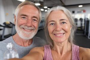 Active Senior Couple Smiling at the Gym Fitness, Wellness, and Healthy Aging. Exercise, Training, and Retirement Lifestyle. photo