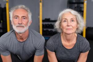 Active Senior Couple Fitness and Wellness in Later Life. A portrait of a healthy, energetic elderly couple working out together a photo