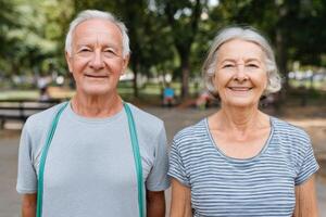 Portrait of a happy senior couple enjoying their active lifestyle in a park. Smiling elderly man and woman, healthy aging, retire photo