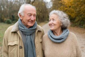 Romantic Elderly Couple Enjoying an Autumn Stroll in a Picturesque Park. A heartwarming scene of love and companionship in nature' photo