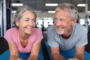 Active Senior Couple Fitness, Health, and Wellness in the Gym. Plank Exercise for Strength, Endurance, and Wellbeing. Teamwork and photo