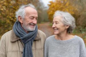 Romantic Elderly Couple Enjoying a Walk in the Autumn Woods. A heartwarming image of love and companionship in old age. Perfect fo photo