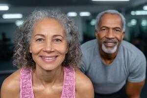 Active Seniors Fitness, Wellness, and a Healthy Lifestyle. This image portrays a fit, older couple working out in a gym, showcasin photo