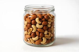 A jar filled with nuts and nuts on a white background photo