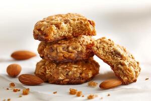 A stack of cookies with almonds on a white surface photo