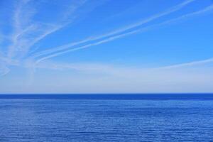 Tranquil seascape with a clear blue sky stretching to the horizon, perfect for promotional advertisements and travel brochures. The serene scene evokes a sense of peace and relaxation. photo
